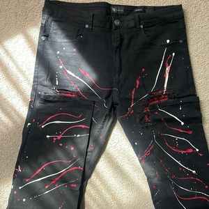 Black jeans with red and white paint splattered